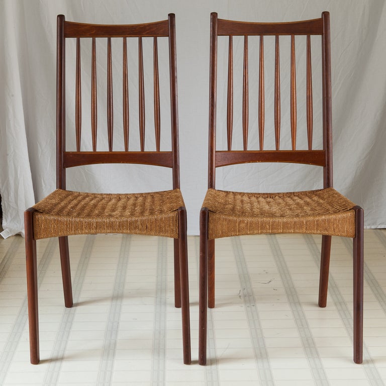 Circa 1960s Scandinavian / Danish teak frame dining chairs with tall spindle backs and woven rope seats. Sold and priced as a set of six. Excellent vintage condition - all rope seats are tight and intact, no fraying,  tears or repairs found. No