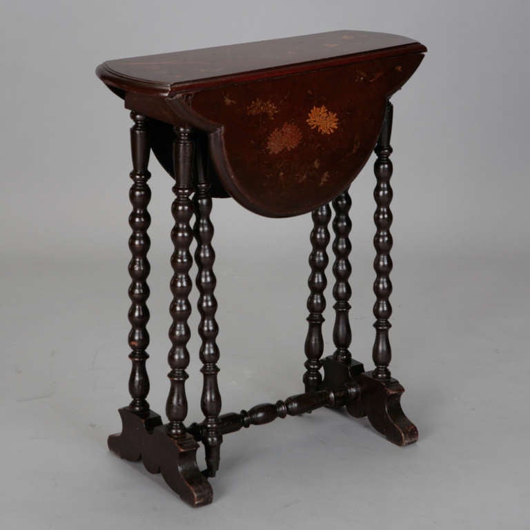 Dark wood English Pembroke table has scalloped edges, turned legs and a hand painted floral design on the table top. Width shown is when table is open. Closed table is 68.5” wide.