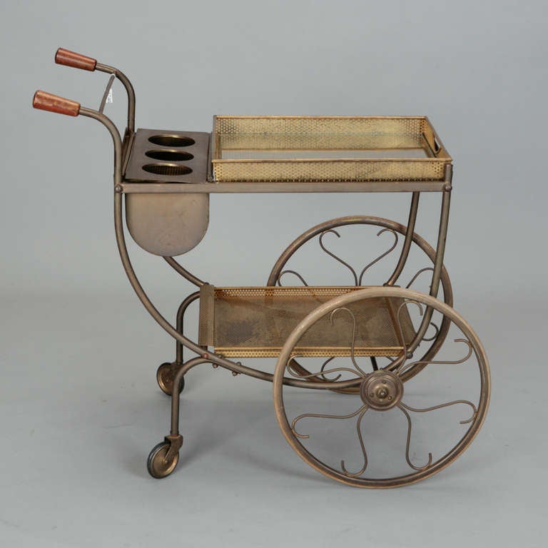 Gold tone metal mesh drinks trolley has two levels of trays and a caddy designed to hold three bottles on ice.