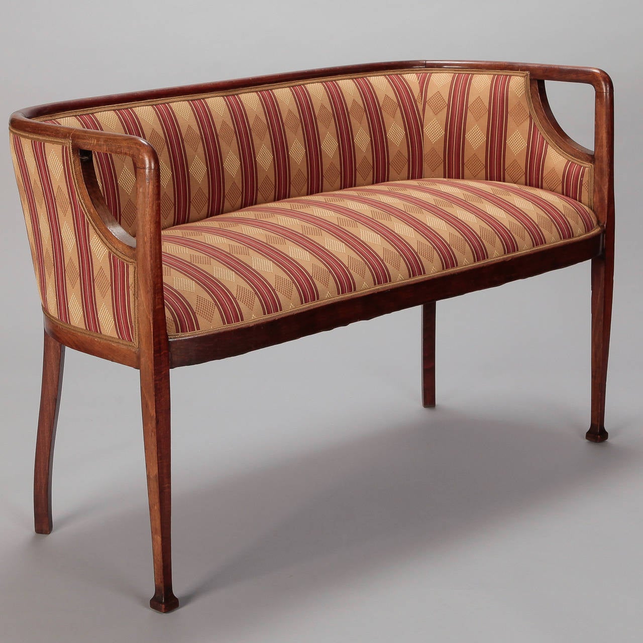 Circa 1930s French settee has sleek wood frame with curved back and slender legs. New striped silk jacquard upholstery. Seat is 20.25” high and 17.5” deep. Arms are 29.5” high.