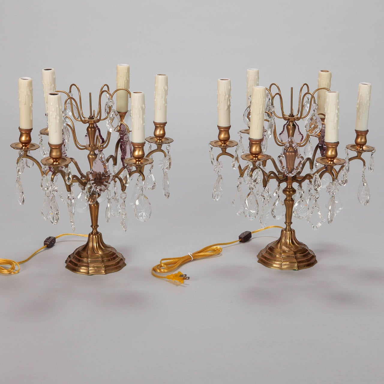 Circa 1900 French six arm candelabra in bronze with large clear and amethyst crystal drops. Electrified for use as table lamps and updated for US electrical standards. Sold and priced as a pair.