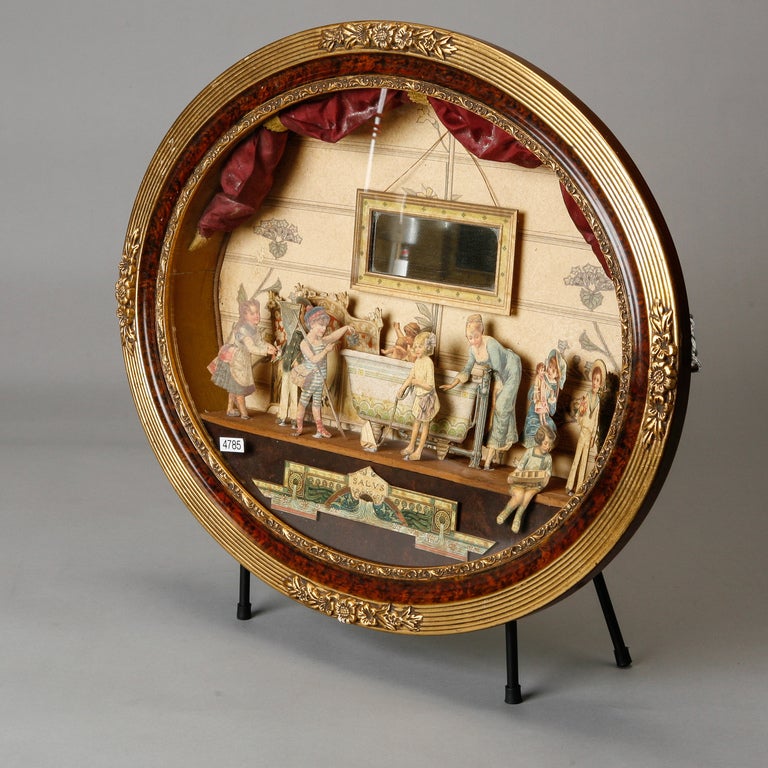 19th century French diorama of cut and colored paper depicting children at play. Original oval gilt frame with floral embellishments. We have another, larger diorama available as well. Please inquire.   