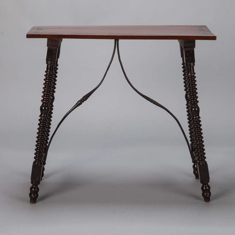Circa 1880s Spanish small console has an oak top with inlaid details, curved iron stretchers and turned ebonised legs.