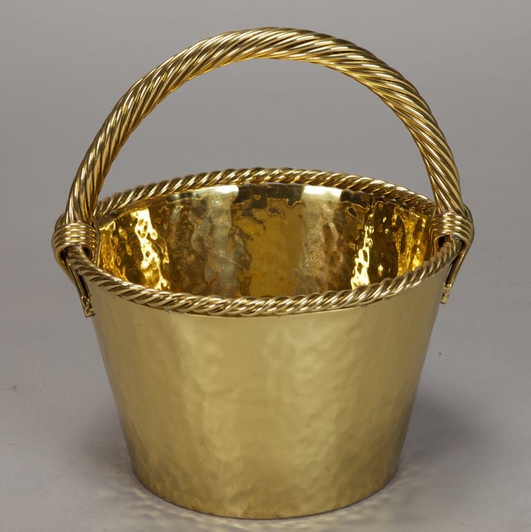 Striking and substantial hammered brass bucket with thick twisted handle and rim. Use it as an ice bucket, planter, centerpiece or decoration.