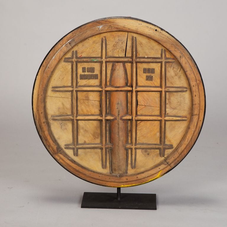 Large circa 1940s round wooden industrial mold with a grid pattern in relief mounted on a custom metal stand.