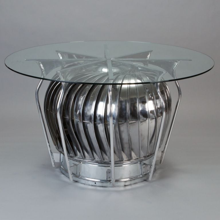 Custom made table base (glass top is not included) features a large, circa 1940s polished aluminum air vent. The vent base spins freely and is surrounded by steel supports that can hold a round or rectangular top. We've shown the table here with a