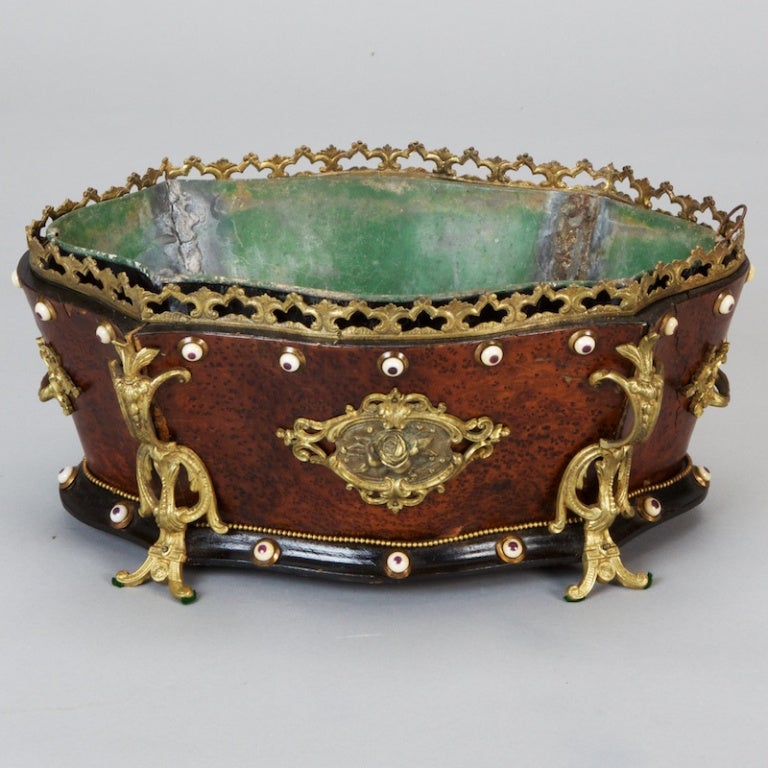 Stunning 19th century French footed jardiniere made of walnut with elaborate decorative brass mounts.