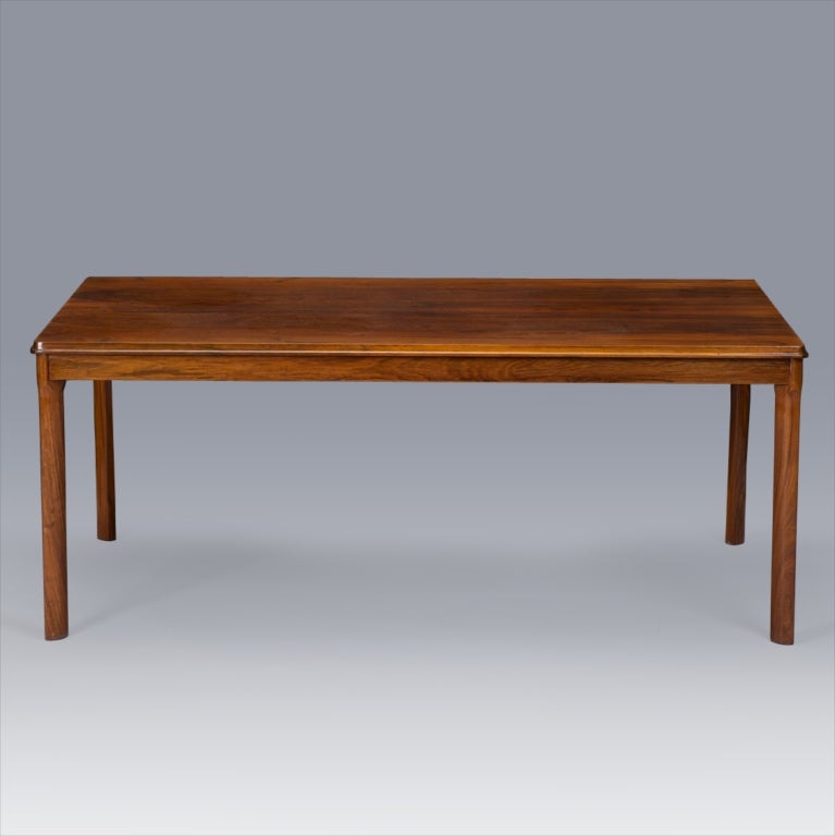 Mid century rectangular coffee table has a classic, streamlined profile and is made of beautifully grained rosewood. Underside of table marked 