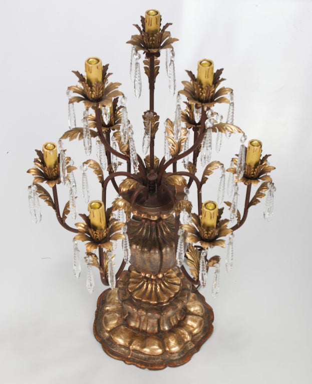 Late 19th century pair elaborate Italian gilt wood lustre lamps. Base and body of lamps are carved and gilded wood, each lamp has 9 candle style lights with candelabra size sockets. Light holders are decorated with gilt tole leaves and several cut