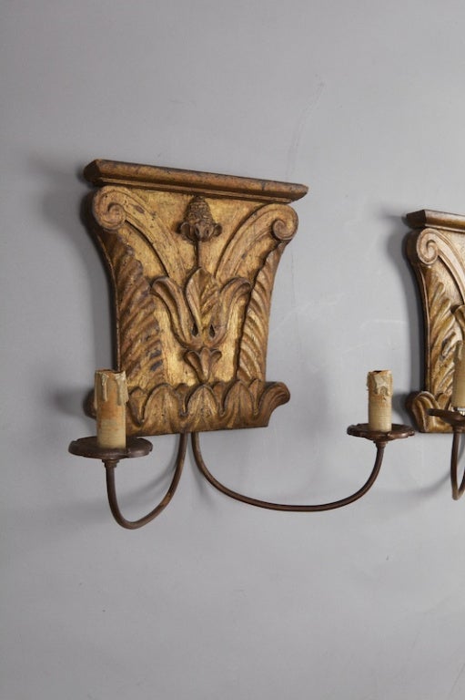 Carved and gilded Italian architectural fragments from the 18th century are the backplates for this pair of two light sconces. New wiring for US electrical standards.