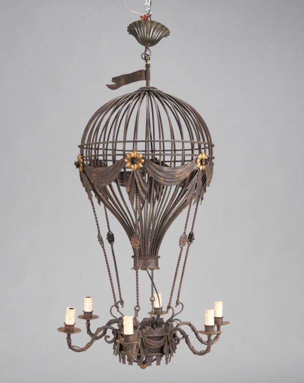 This black metal fixture is shaped like a hot air balloon and has six lights.