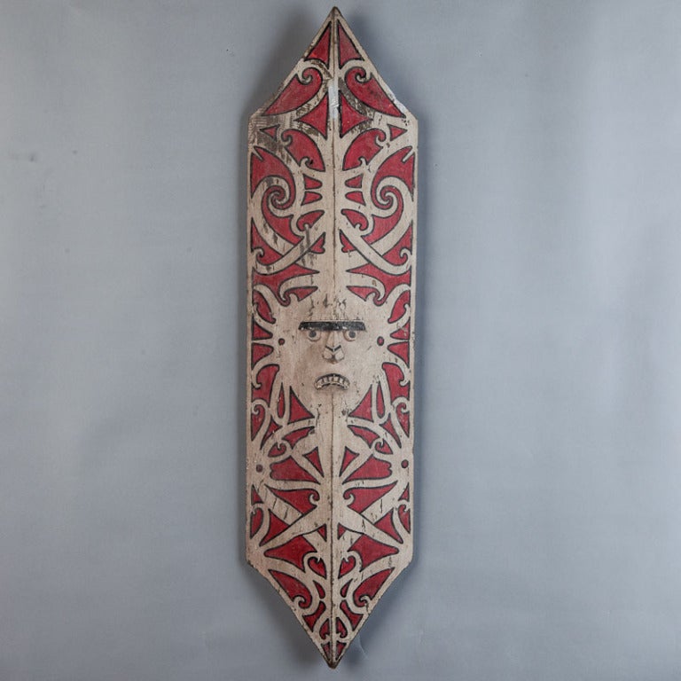 Circa 1970 carved and painted wooden shield from the Orang Ulu of Borneo with carved facial features. We have two other similar shields available - please inquire if interested in a group price.