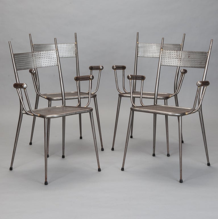 Great set of four French mid century industrial armchairs. Seats, backs and rolled armrests of metal mesh, slender tapered legs. 
Arm Height:  25.5”
Seat Height:  17.75”
Seat Depth:  14.5