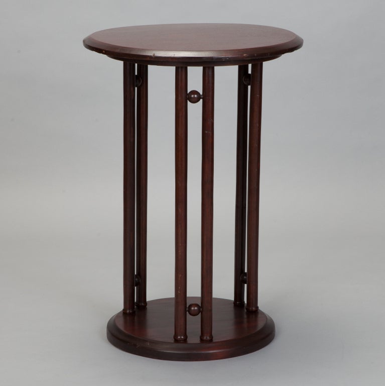 Circa 1910 Josef Hoffmann side table has round table top with round pedestal base and three double column supports with spherical accents.