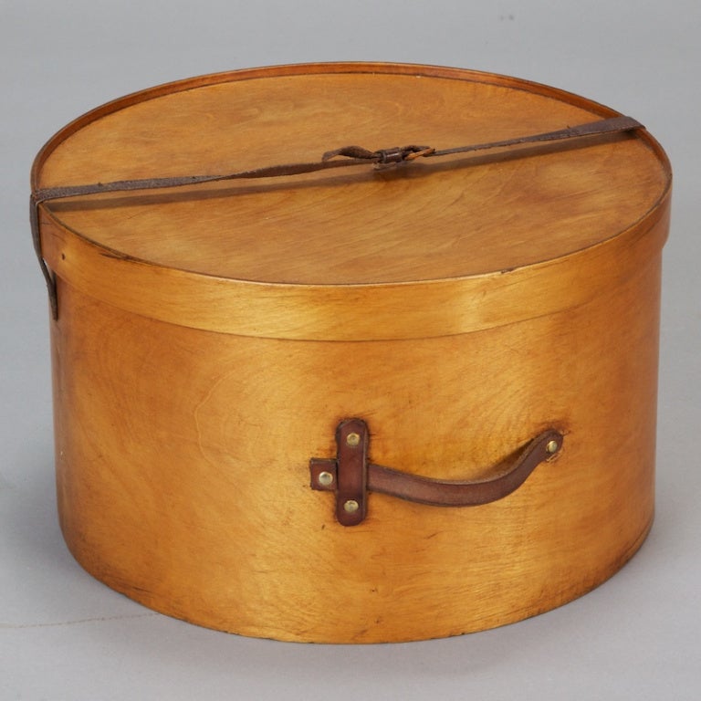 Circa 1920s English wooden hatbox with leather handle and straps. We also have another similar hat box of approximately 20