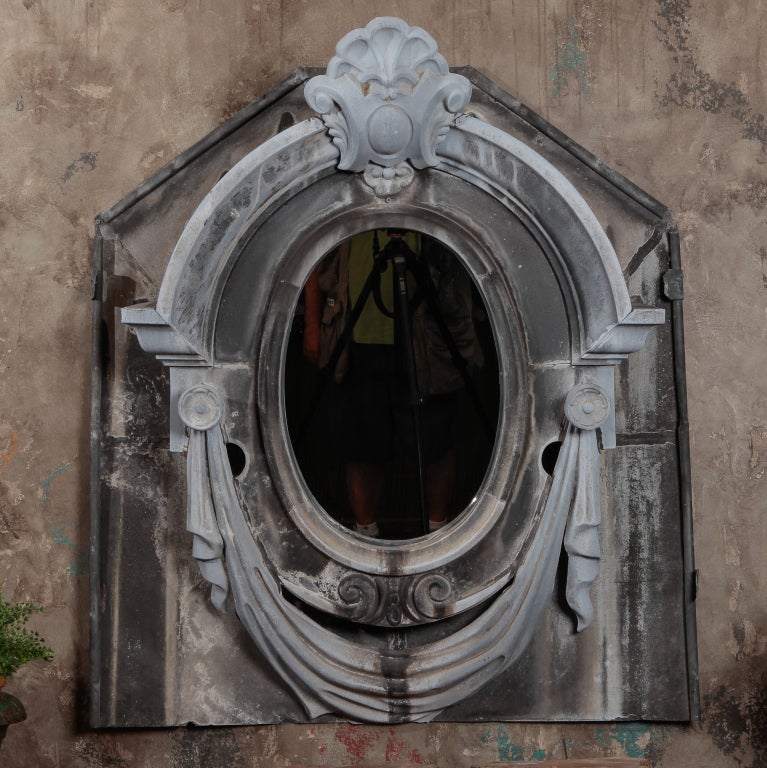 Circa 1920s neoclassical style zinc architectural window frame has been fitted with a mirror.