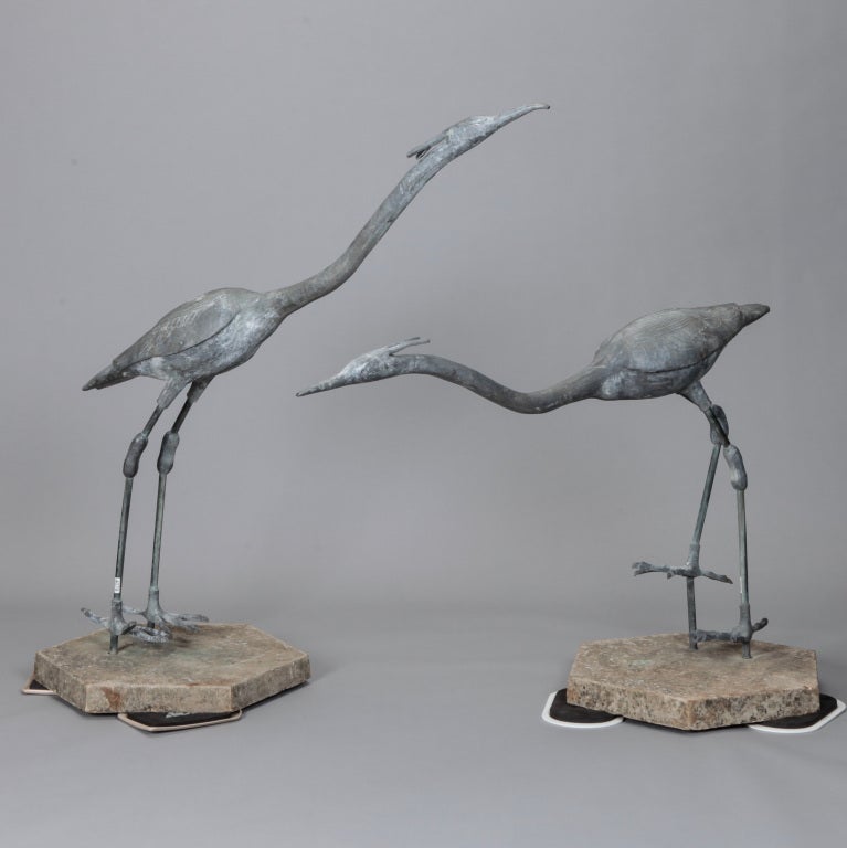 Pair of large metal/iron garden heron sculptures with heavy stone bases. Sold and priced as a pair.