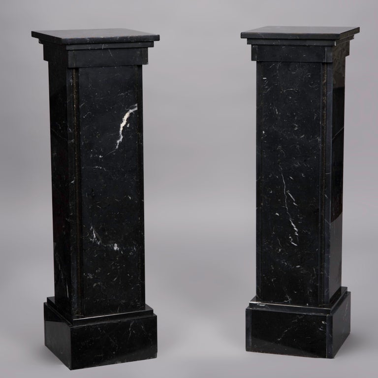 This classic pair of black marble columns make great display stands for plants or artwork.