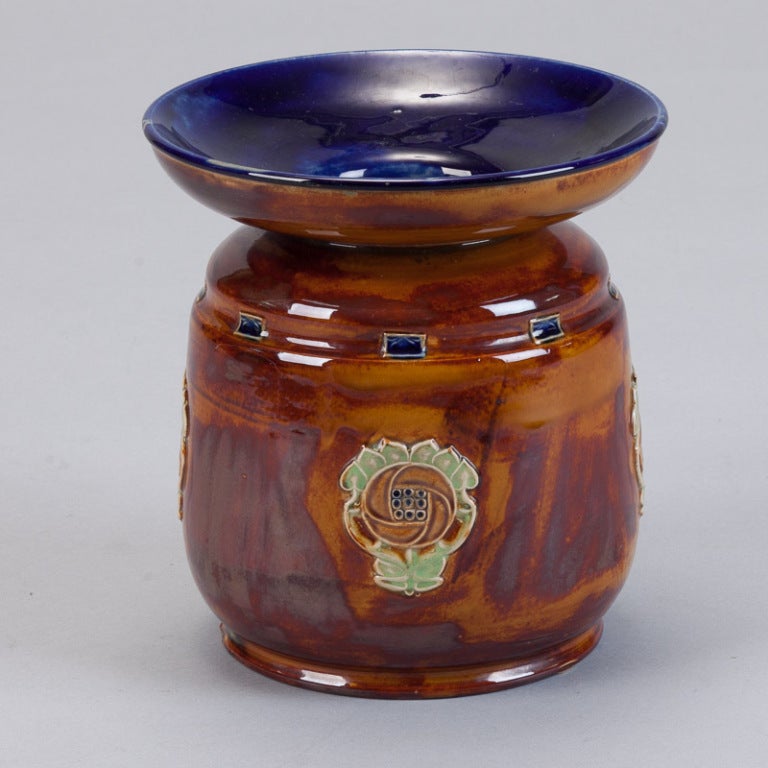 Late 19th century Royal Doulton Lambeth vase has a floral motif, wide flared neck and a royal blue interior.