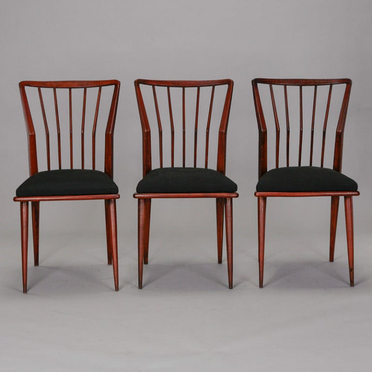 Circa 1939 set of six Italian dining chairs by Maurizio Tempestini with stylized angled spindle backs, black upholstered seats and tapered legs. These chairs are rare, early examples of this iconic designer’s work and according to another source,
