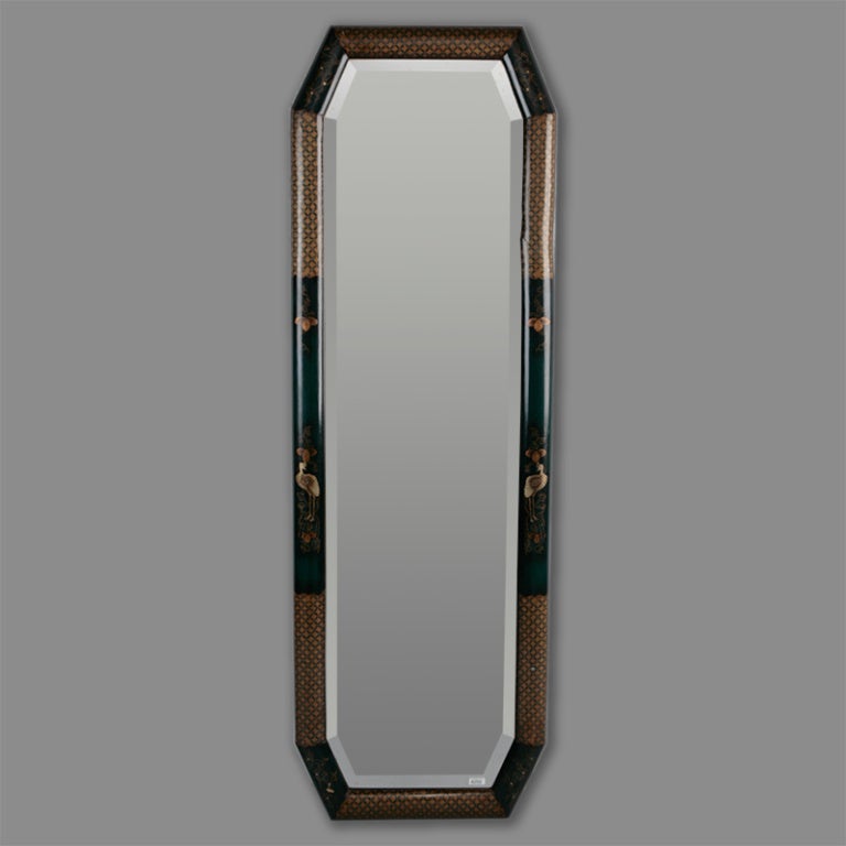 Circa 1920s tall narrow eight sided Chinoiserie mirror has a rich blue painted frame with gilded lattice and birds.