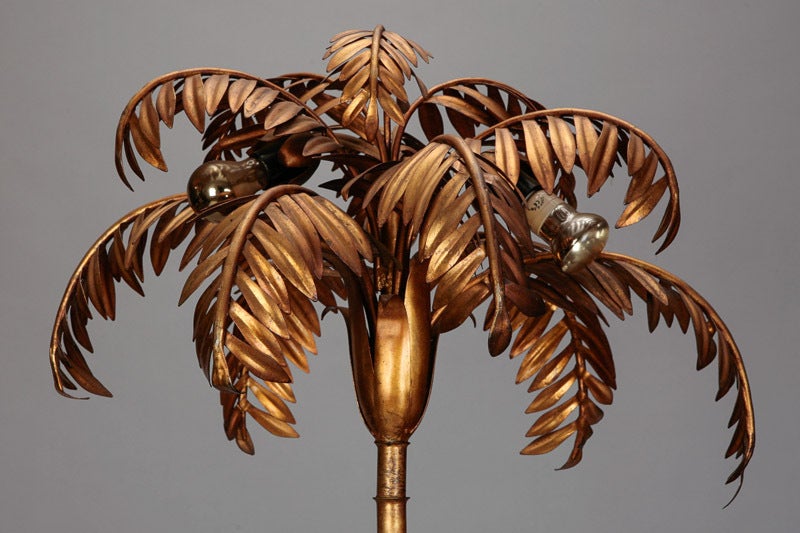 Beautifully rendered brass palm tree floor lamp with black glass table top. Attributed to Maison Jansen.