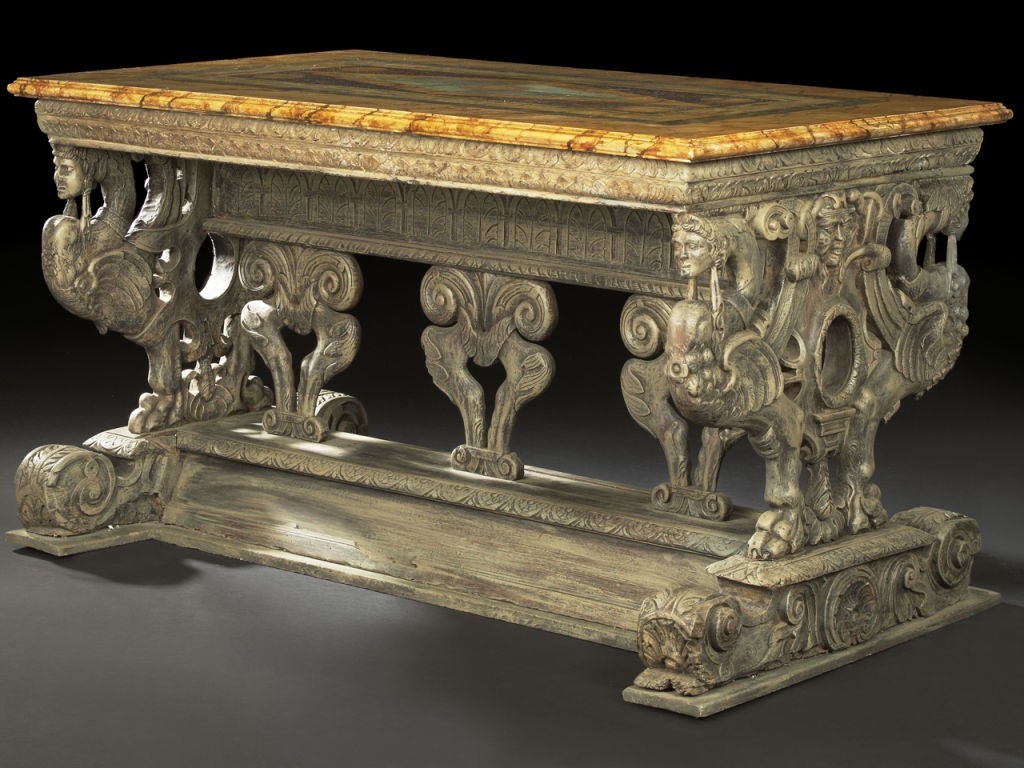 Polychromed and faux-marbre center table, in the Renaissance taste, the rectangular top (replacement) simulating geometric-patterned specimen marbles, raised on two heavily carved griffin end supports and three lyre-form supports to a molded H-form