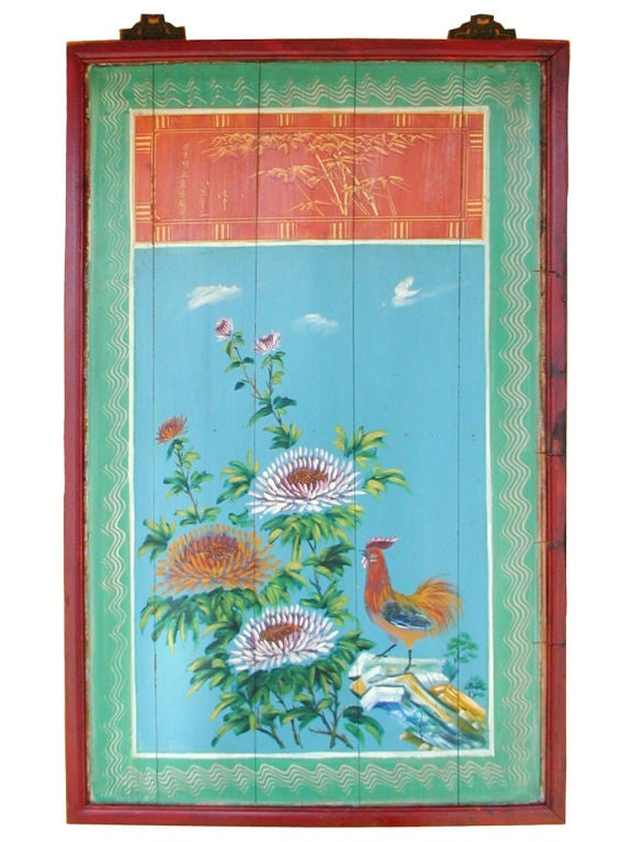 Pair of vibrantly painted wooden panels, each depicting floral and bird designs, framed in faux bamboo; with decorative brass hardware.