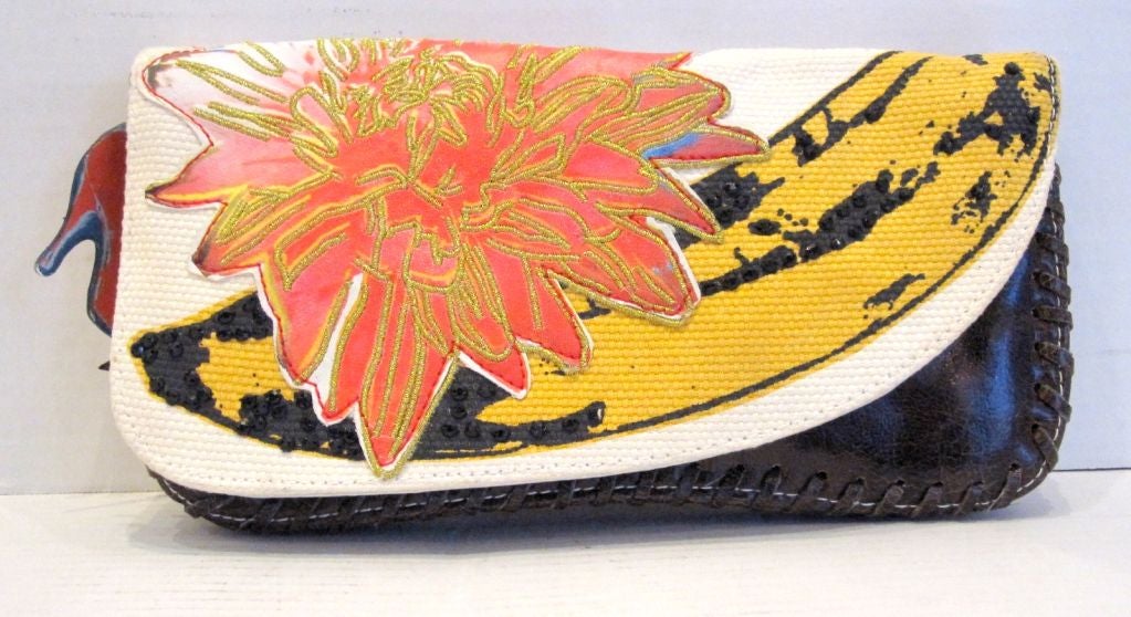 A Gorgeous Andy Warhol Needlepoint and Leather Clutch, with Embroidered Applique Flower, and Black Stones. This Clutch has the Original Shoe Tag, as well as, an Andy Warhol Couture Ribbon.