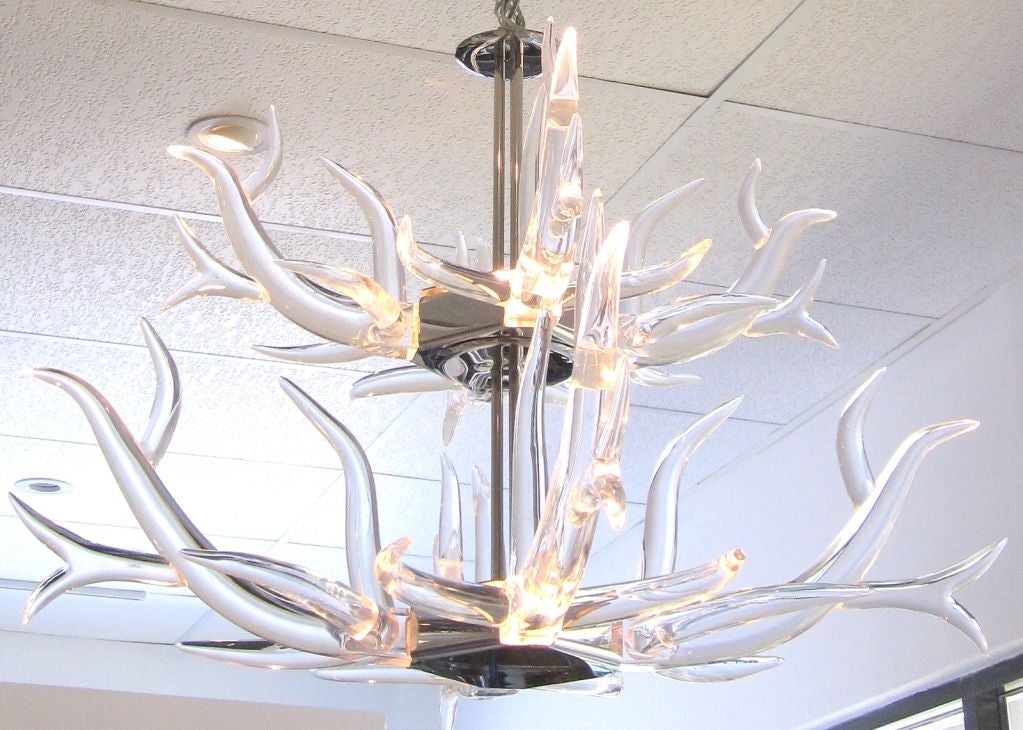 Beautifully Shaped Thick Lucite Antlers are Illuminated and Supported by a Mirror Polished Stainless Steel Base, Creating a Very Sleek and Modern Chandelier.