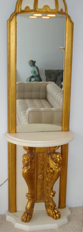 A gorgeous Hollywood Regency Marble and gilted carved wood console table with mirror and illuminating canopy, signed Phyllis Morris. 
 
Phyllis Morris(1925-1988) was known for her extravagant designs, such as her throne chairs, unique cabinets and