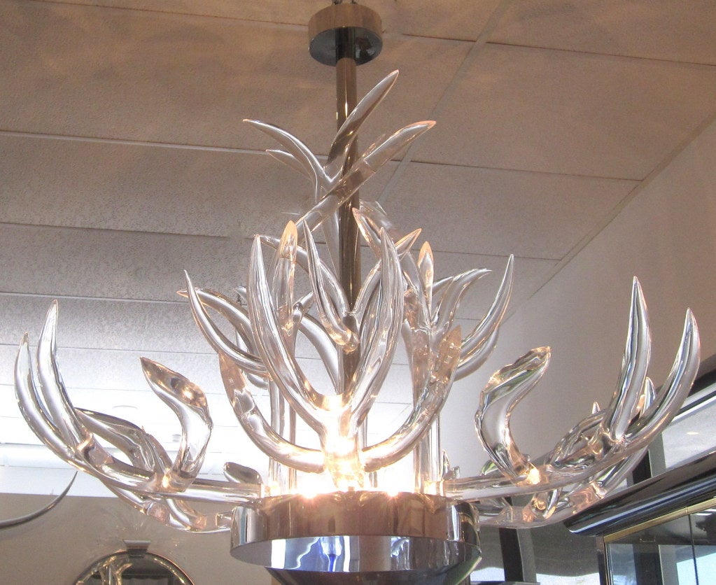 Custom made mid-century sculpted lucite antlers and mirror polished stainless steel chandelier.