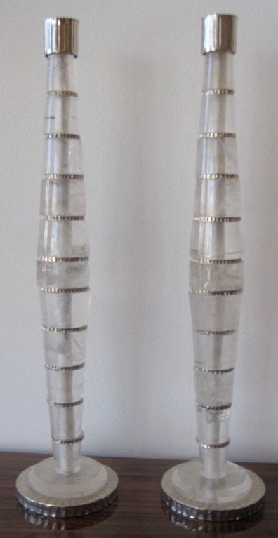 Pair of Sublime Polished Rock Crystal Candlesticks with Silvered Hand Chiseled Metal Base and Spacers.