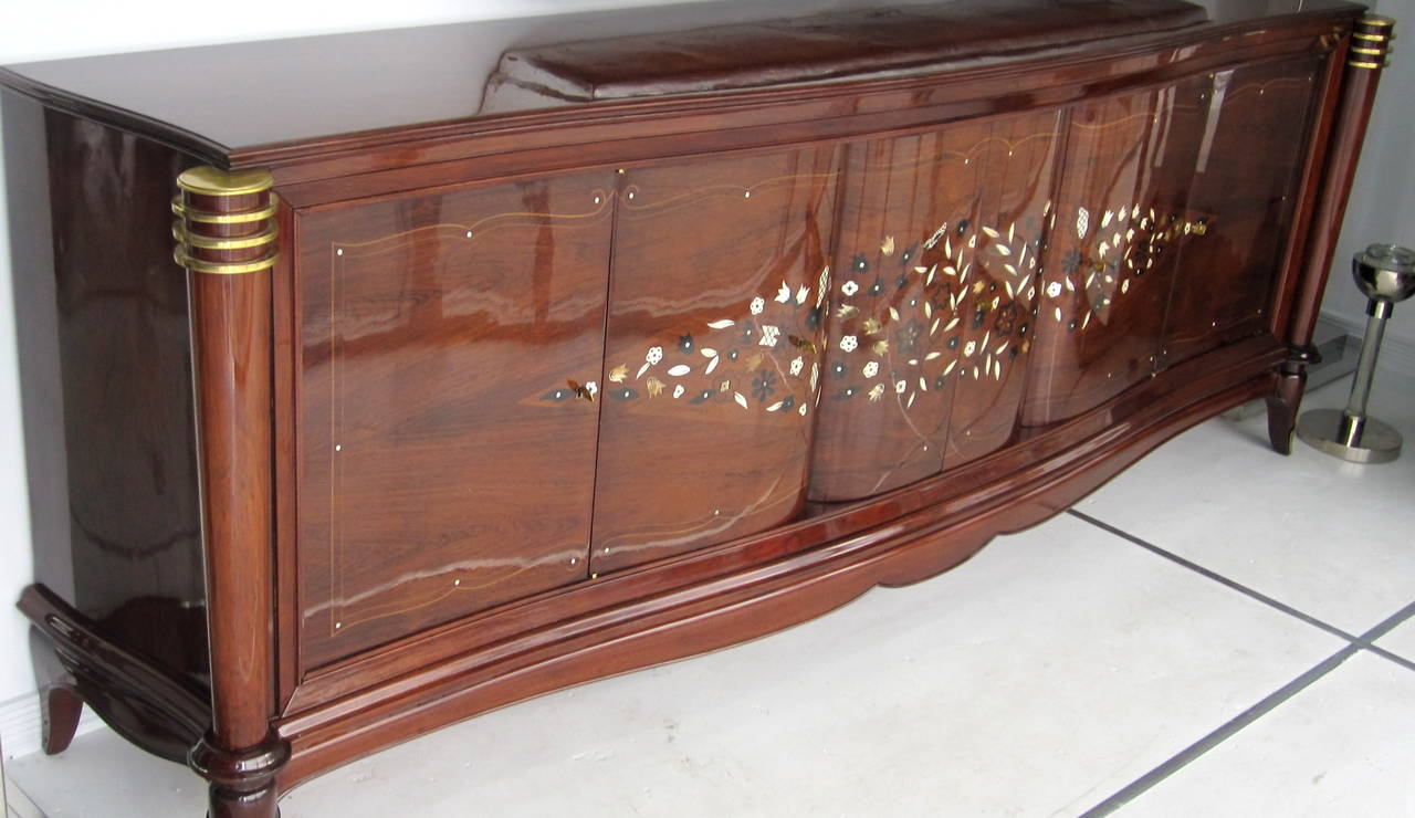 Gorgeous details on this French Art Deco buffet in the style of Jules Leleu in palisander wood with marquetry, mother-of-pearl, nacre and bronze inlay designs. The bronze caps, rings, sabots and original keys add a very chic note, plus the lemon