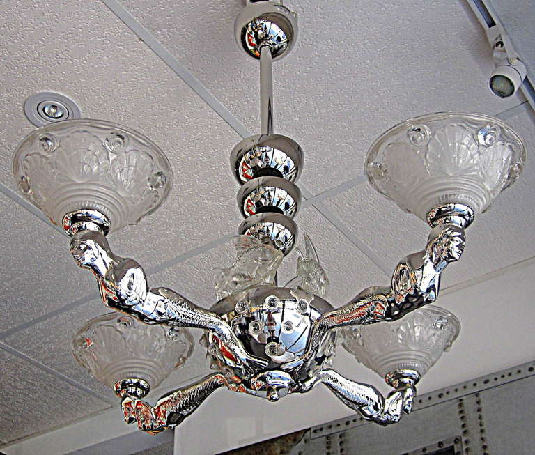 Excellent French Art Deco Chandelier with Nickel Dipped Cast Bronze Mermaid Base and Molded Glass Shades with Shell Motifs. Beautiful Molded Glass Fish are the Finishing Touch on this Unique Deco Chandelier by Petitot.