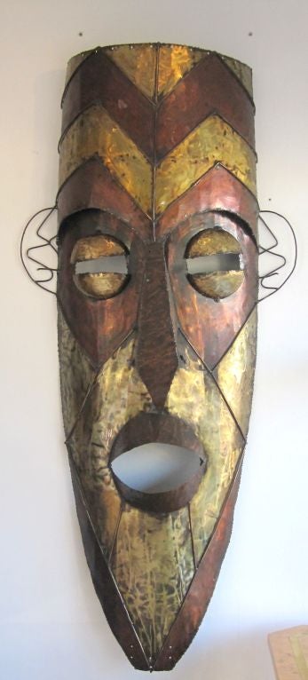 A monumental welded brass and copper African mask. Highly decorative!