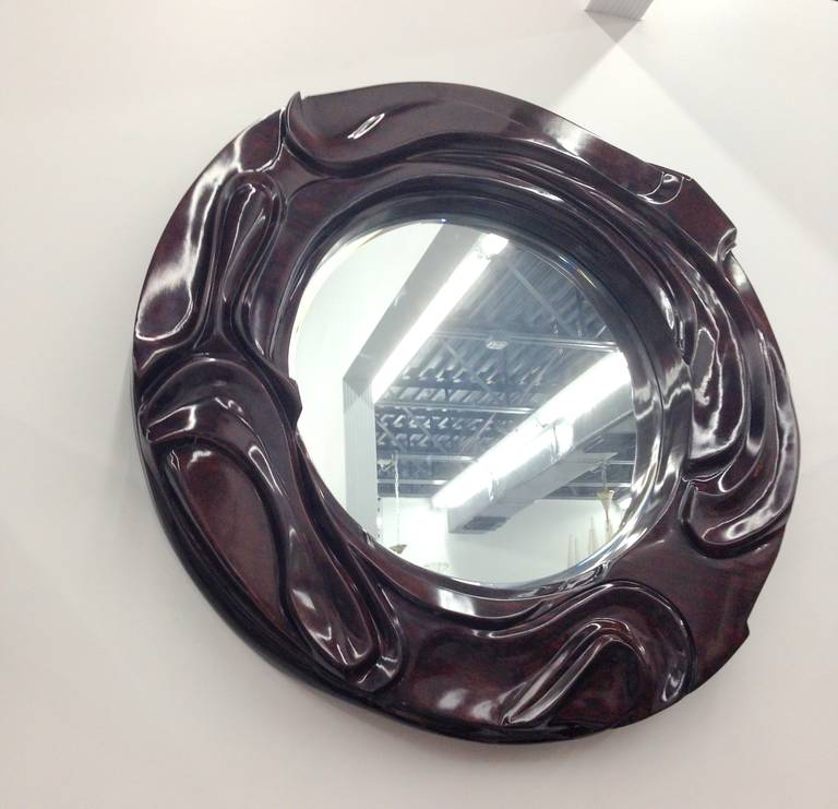 Sculpted solid and thick, hand-polished mahogany mirror.