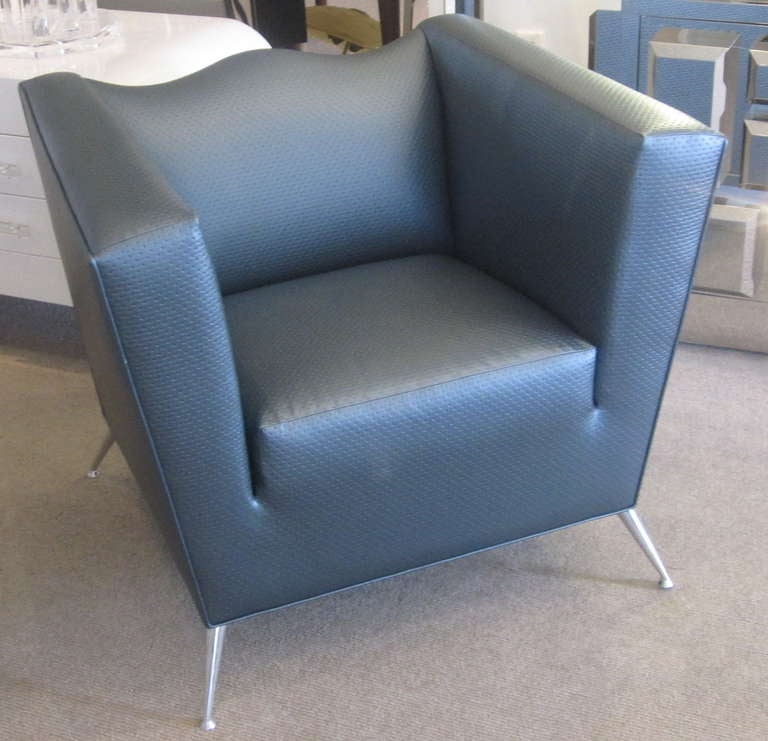 Beautiful tapered legs in metal and metallic grey vinyl upholstery in excellent condition combine creating a very modern design.
