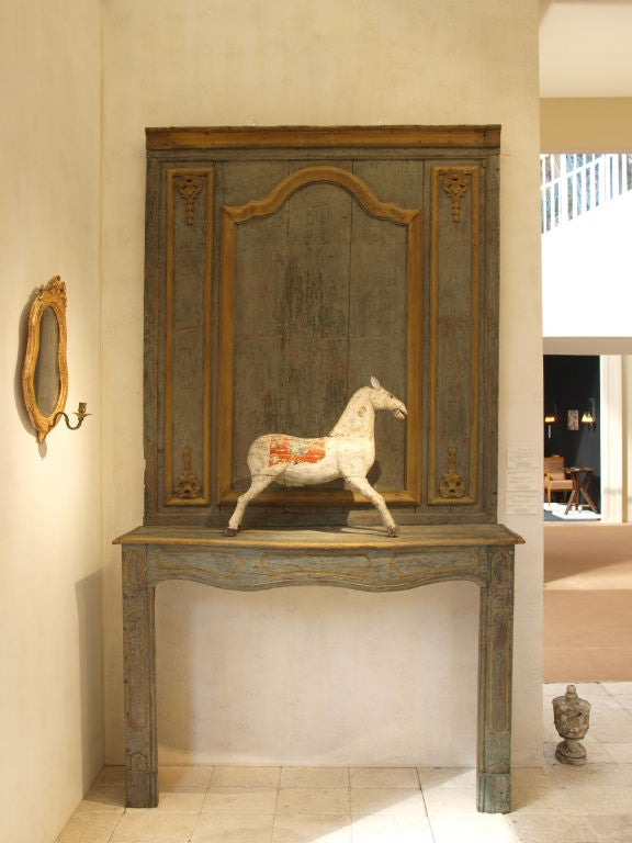 A French late Eighteenth Century Carved Wooden Fireplace with the Original Painted Decoration from the Region of Provence
