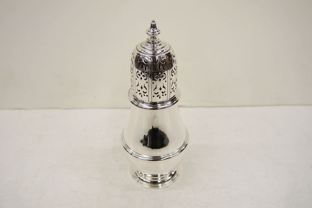 A baluster shaped Sterling Silver Muffineer/Sugar Shaker with pierced top.  This was made in England and imported into Canada by the famous firm of Birks. Weight: 152 grams