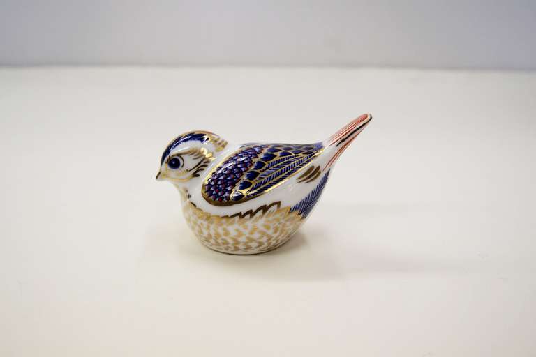 This bright and cheerful porcelain Paperweight model has blue, red and gold Imari flashing on the head, wings and tail.  The body is white with the feathers represented in gold.  Made by the famous English firm Of Royal Crown Derby.  Circa. 1990