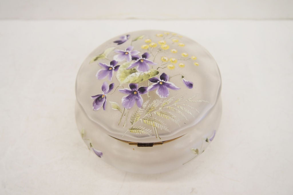 A hand painted with jewelling satin glass Powder Jar with Swan puff.  The puff handle is in the form of a jewelled swan.  The decoration to the lid shows flowers and ferns.  There is no maker's mark.