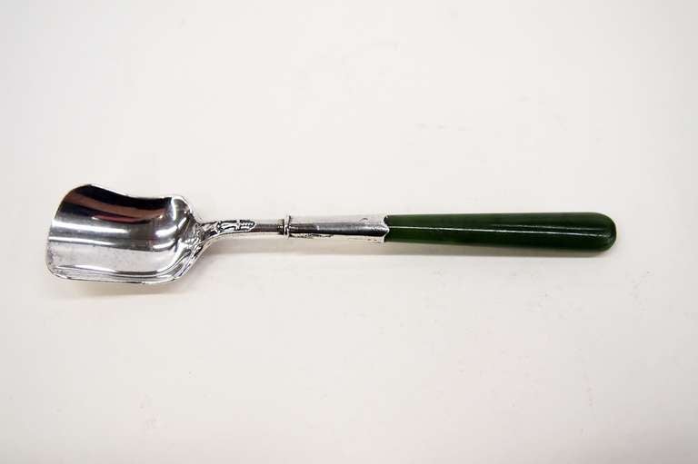 An antique English Sugar Shovel with an unusual Jade (Jadeite) handle.  It is
hallmarked for Sheffield, 1903.   The makers are Richard Martin and
Ebenezer Hall. There is worked decoration on both sides where the handle joins the bowl.