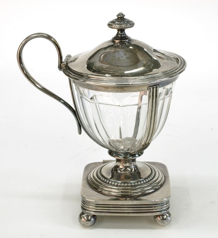 An elegant Silverplated and Cut Crystal lined Mustard/Soy sauce Pot; the whole standing on four bun feet.  From the famous French firm Christofle.