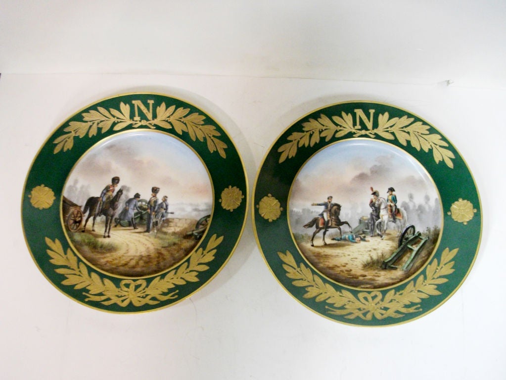 A very decorative pair of hand painted Napoleonic Porcelain Plates depicting the battle of Montereau and the battle of Austerlitz. Heavy gilt decoration to rims with 'N' and laurel leaves.  Marked Sevres on back.