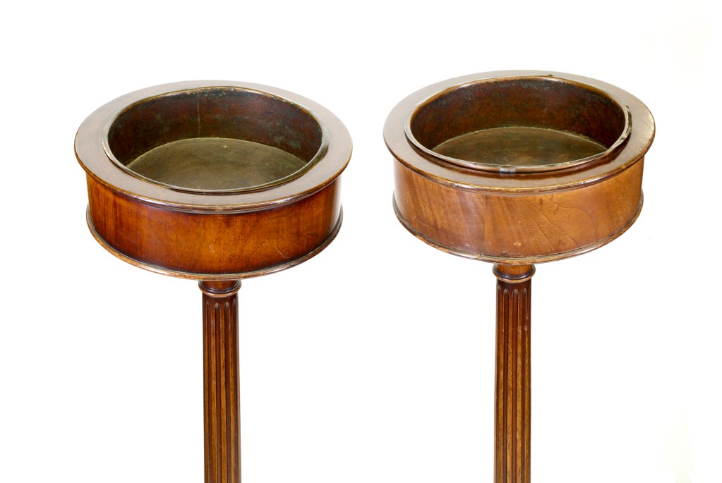 A very hard-to-find pair of elegant Georgian style Mahogany Fern Stands with reeded columns and tapering legs terminating in ball feet.  The inserts are copper drip pails.  Almost certainly made in the USA and from the 1920-30 period.  