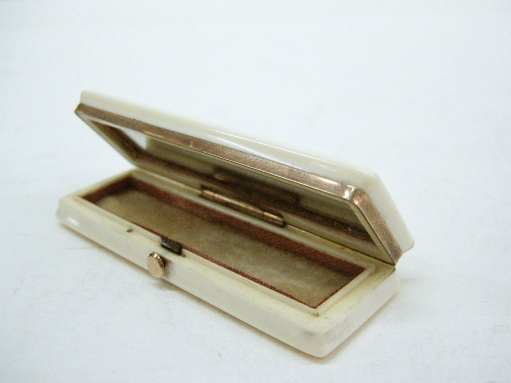 An English Georgian ivory Toothpick Holder with rose gold fittings and inset into lid mourning memento locks of hair.  Gold placque on reverse with initials.  A mirror is concealed in the inside lid.