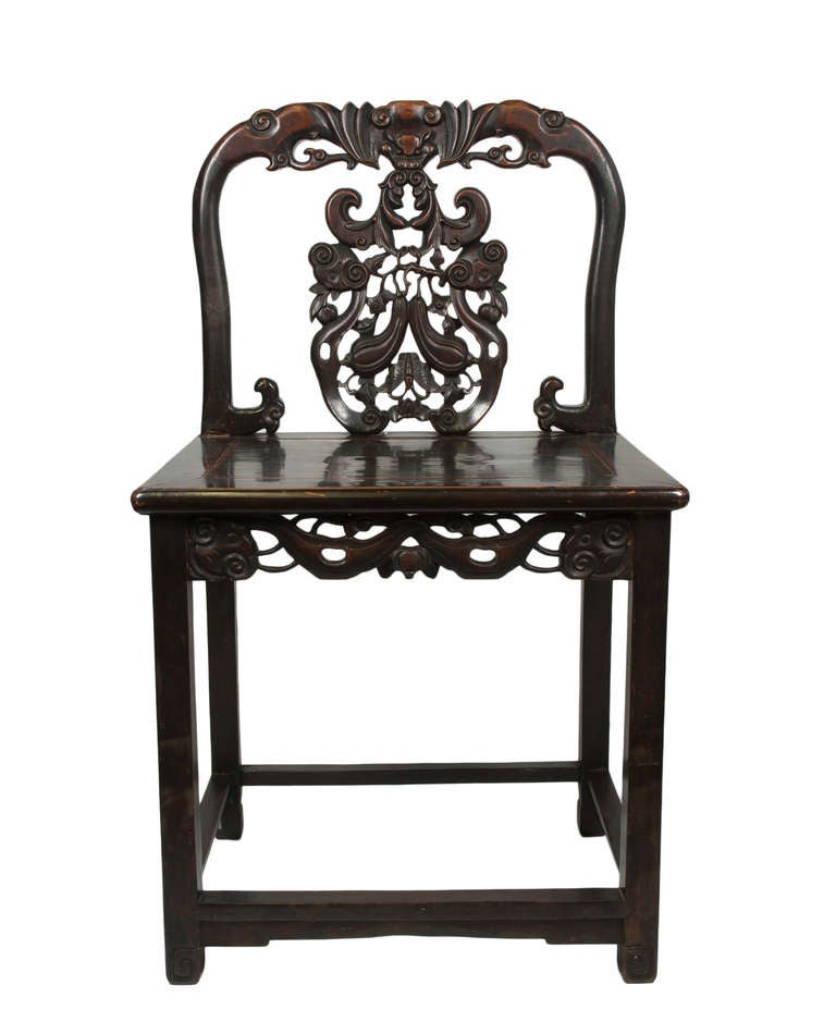 An ornate hardwood Chinese Chair with shaped back rail and carved back splat incorporating a bat decoration centre top and a butterfly centre bottom.  This chair has a good patina  of age.
We do not know which asian hardwood was used in its con-