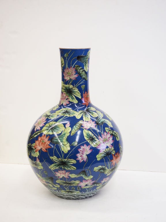 This is a very large Chinese hand painted Porcelain Vase decorated with lotus flowers on a blue background.  It bears the Qianlong Mark but we believe it to be a twentieth century copy say circa. 1930-50 as it came out of an Canadian estate.
