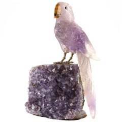Amethyst carved parrot with silver claws and tiger's-eye beak.